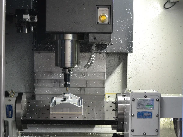 4-axis CNC milling setup machining a part with side-wall features